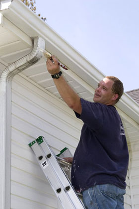 A sydney exterior house painter, painting facia, eves, gutter and cladding.