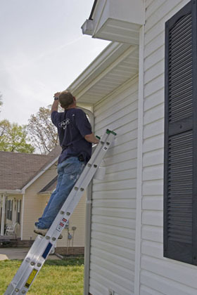 A sydney exterior house painter, painting facia, eves, gutter and cladding.