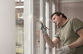 A sydney house painter, painting windows and doors.